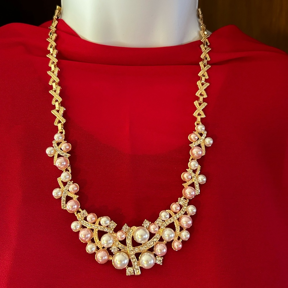 This set of gold and pearl necklace, bracelet, earrings, and an adjustable ring.